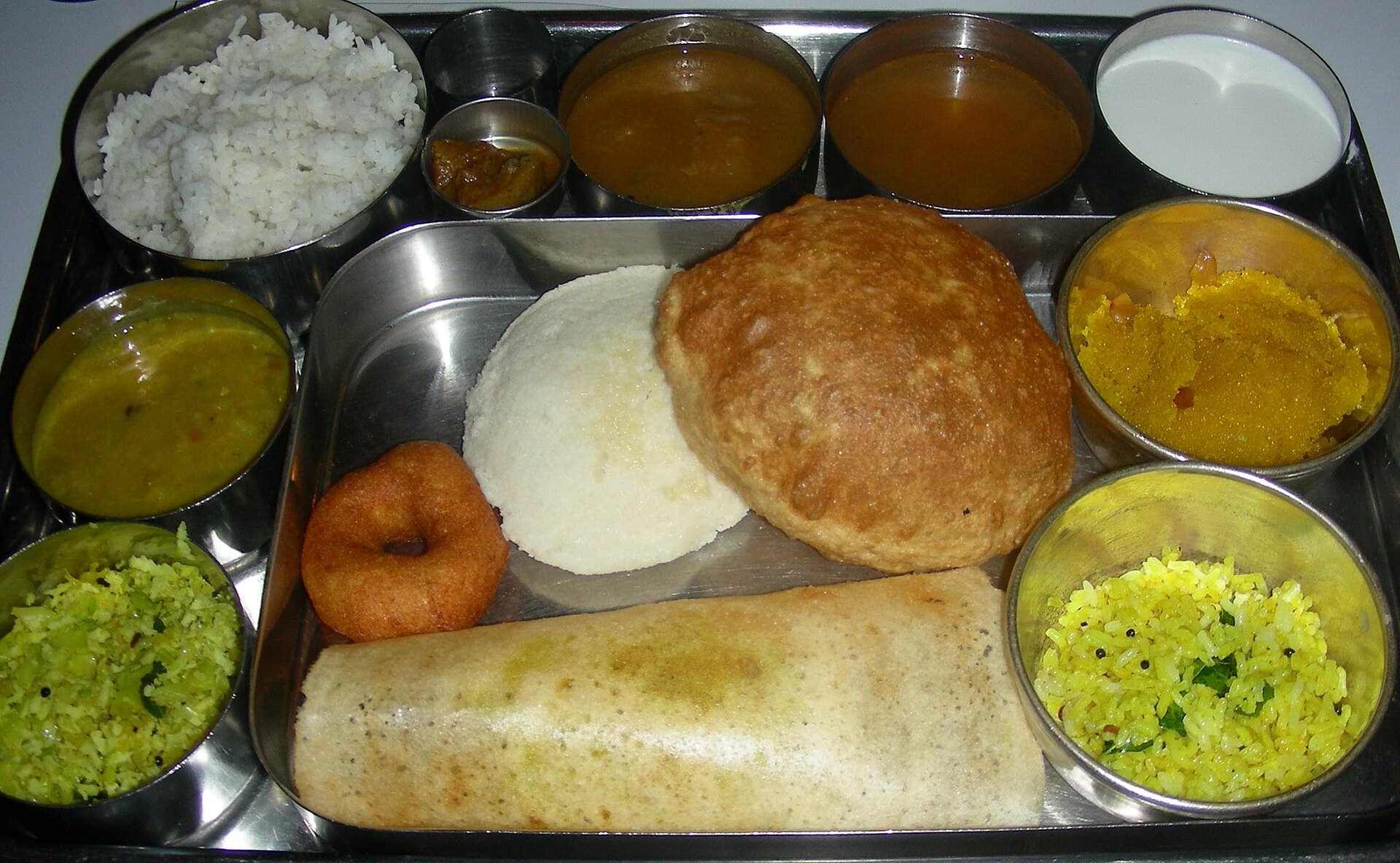 A South Indian thali with dosa, vada, poori and chutneys